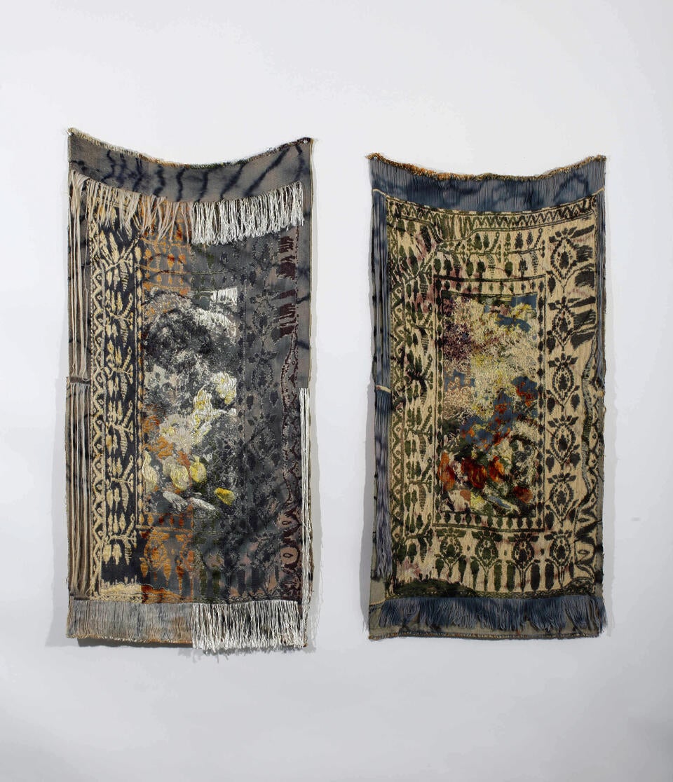 image of two woven textiles depicting a hybrid digital pattern hung on a white wall.