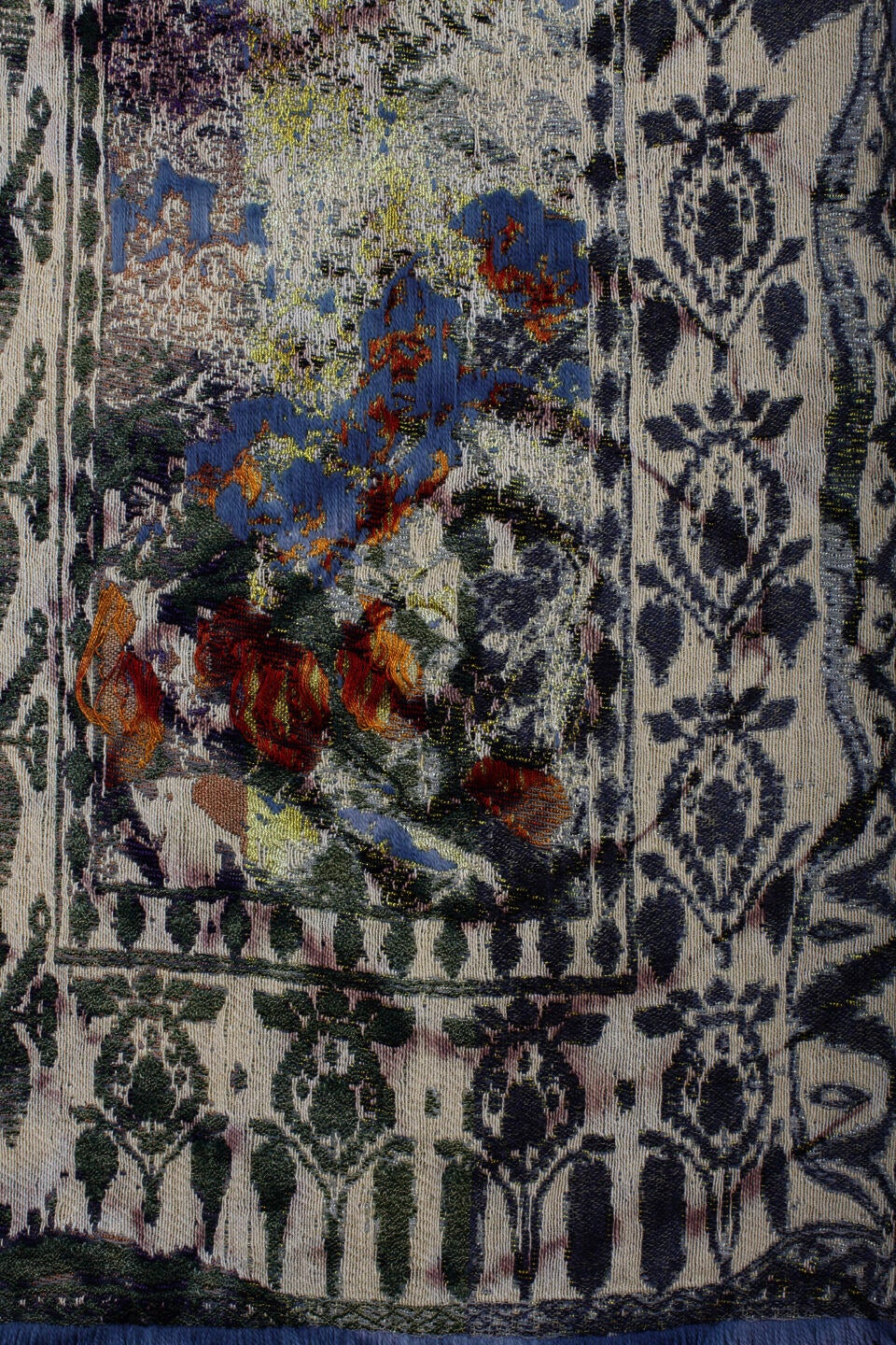Close-up detail of a woven textile depicting an abstract floral pattern in a washed-out color palette.