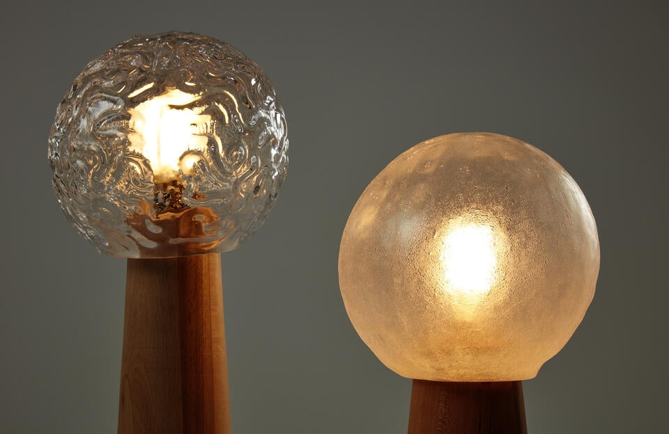 Detail of Table Lamps made of glassblown glass, beech, cherry and lightbulb.
