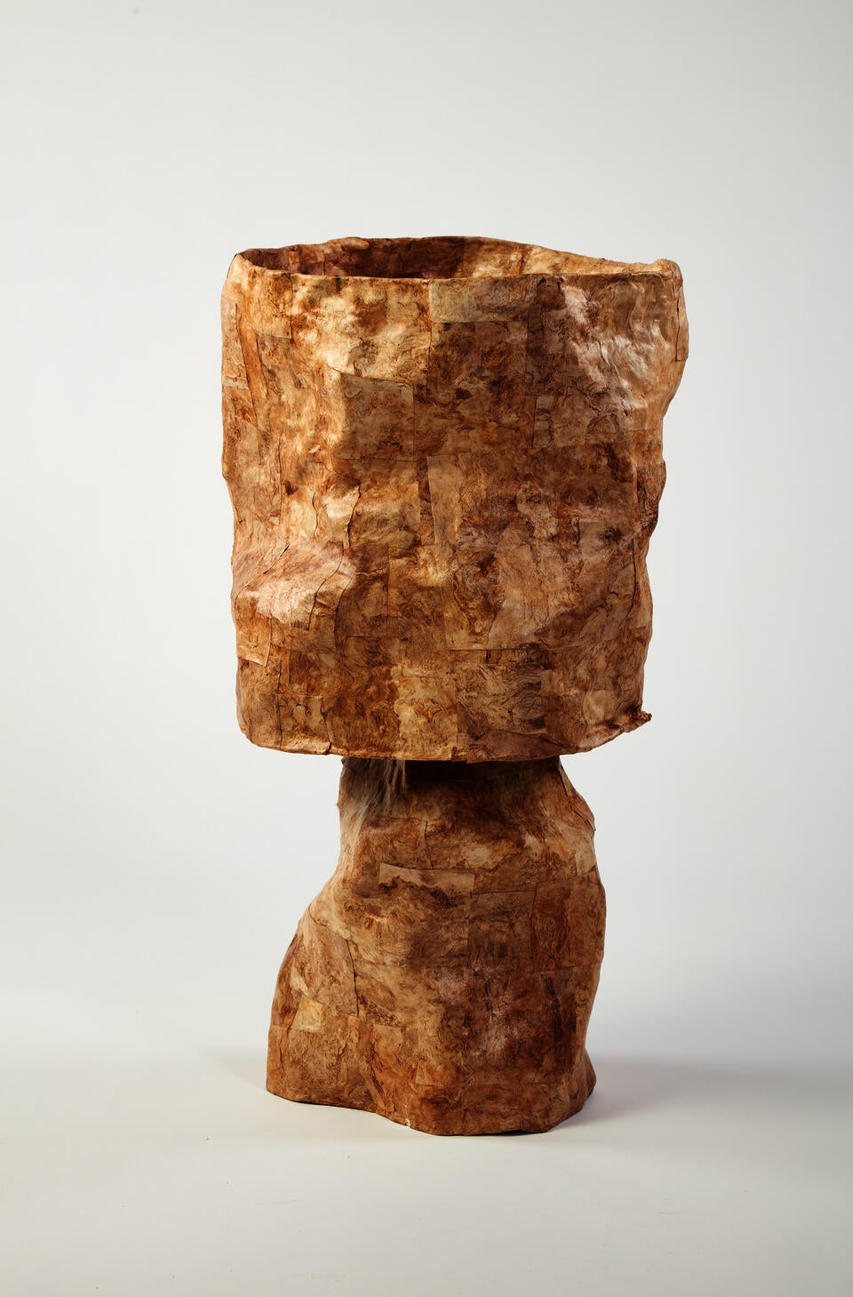 This golden hued lamp is made of paper with vivd swirls of naural fibers that move in all directions. The paper is cut into squares and collaged on the lamp shade and base in assorted sizes.