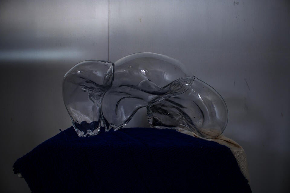 Three blown bubbles over a plaster cas, the artist's torso,  coated in graphite powder. The three bubbles are significant to the stages of adulthood and her identity. 