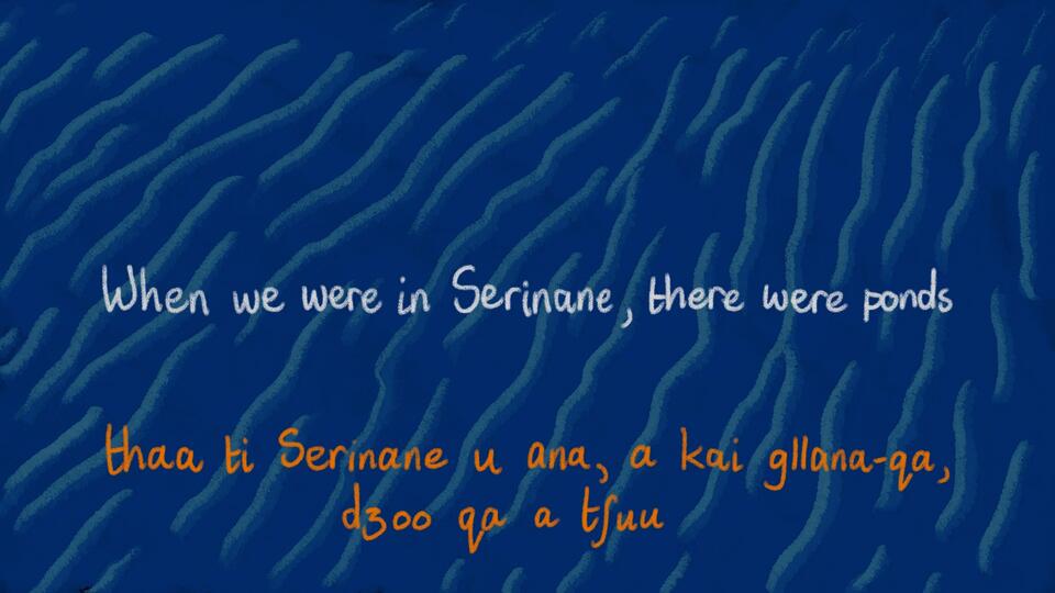 Blue water background with light blue waves. English Text reads: ""When we were in Serinane, there were ponds."" Sasi text below reads: ""thaa ti Serinane u ana, a kai g//ana-qa, dzoo qa a tshuu""