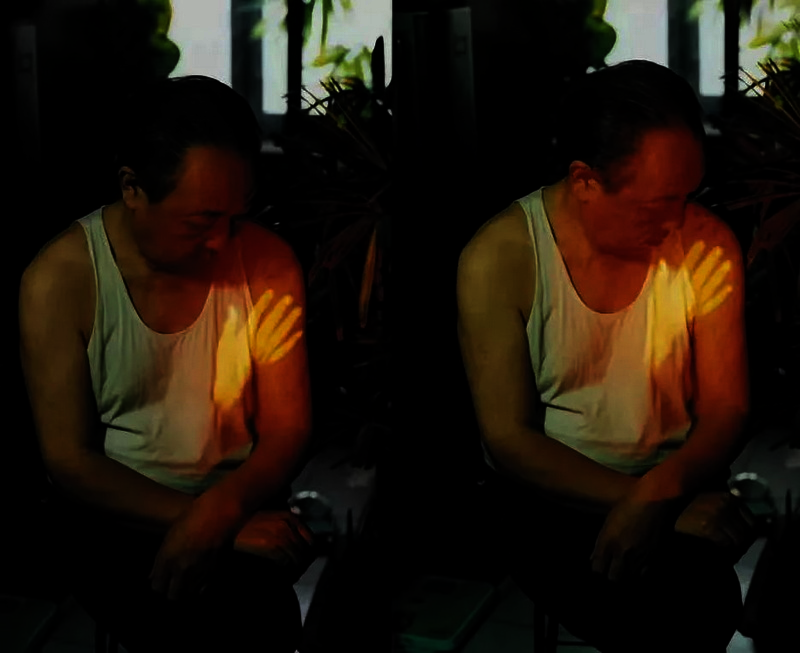 A hand is projected on the body of the artist's father, it is touching him.