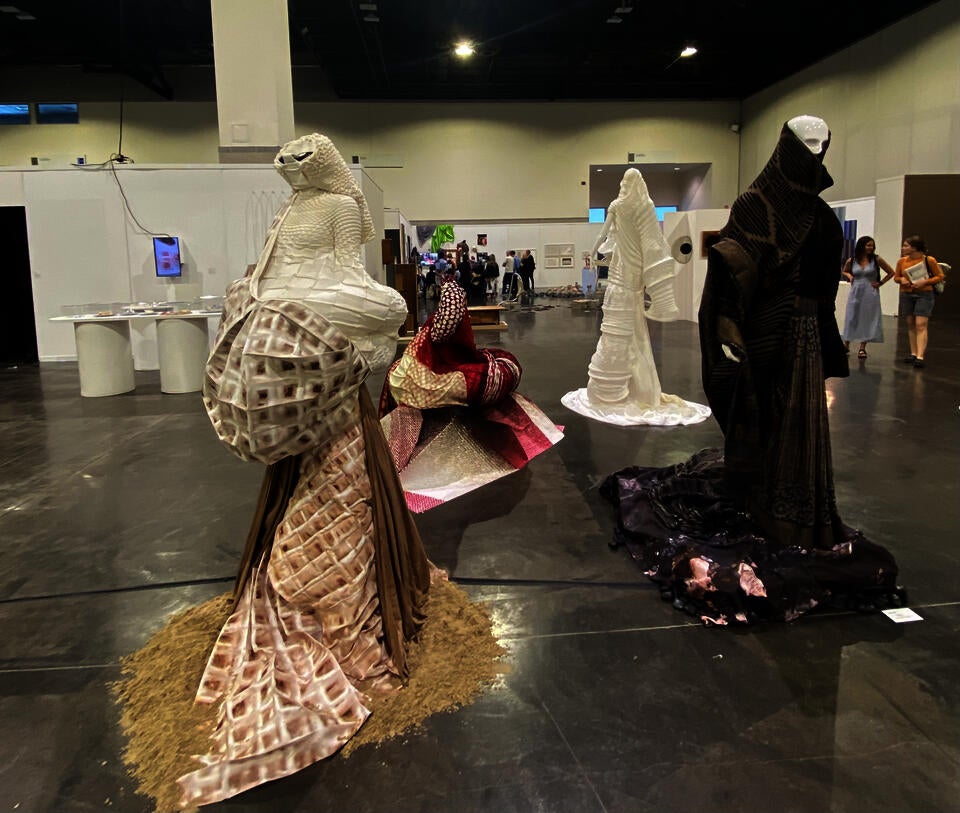 Circling the four garments, the space and path complete the form of a square.