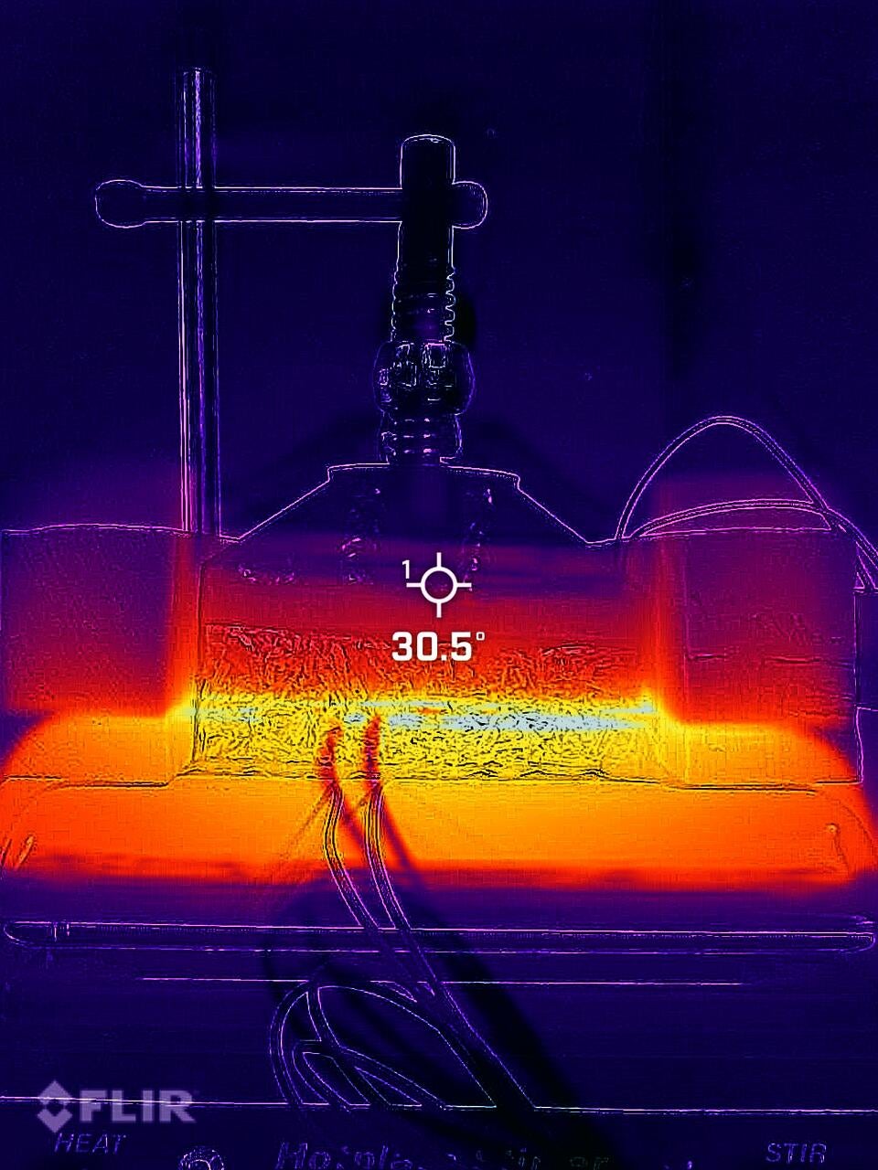 An infrared photograph of a thermal conduction test on a Japanese Knotweed composite block showing a temperature gradient.