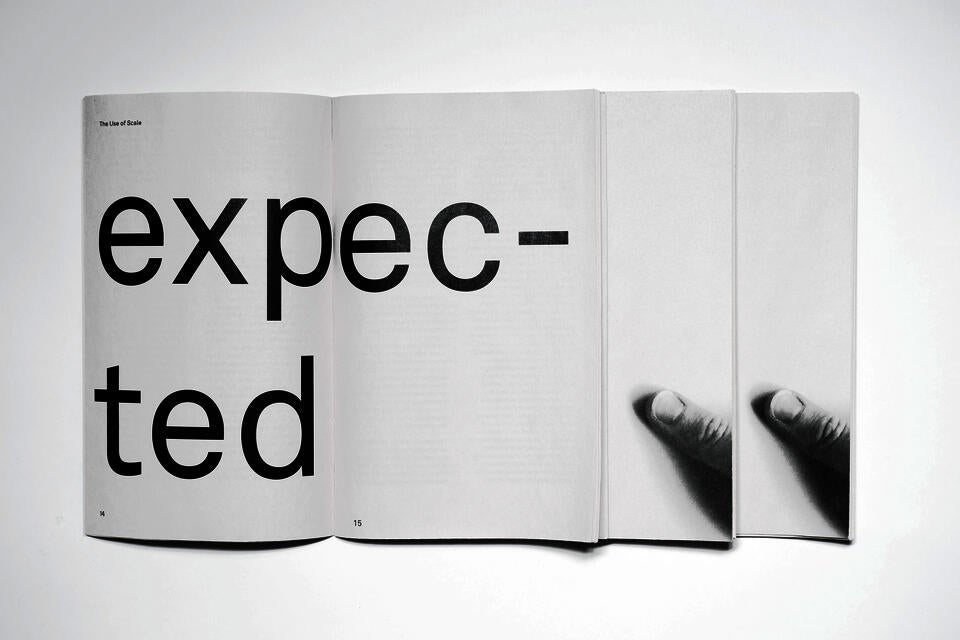 Three books laid out. One is open, reads 'expected'. The other two feature a photo of a thumb holding the book.