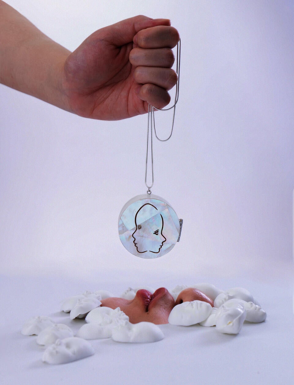 Mother-of-pearl embellished locket necklace, with laser-engraved pattern of two side faces.