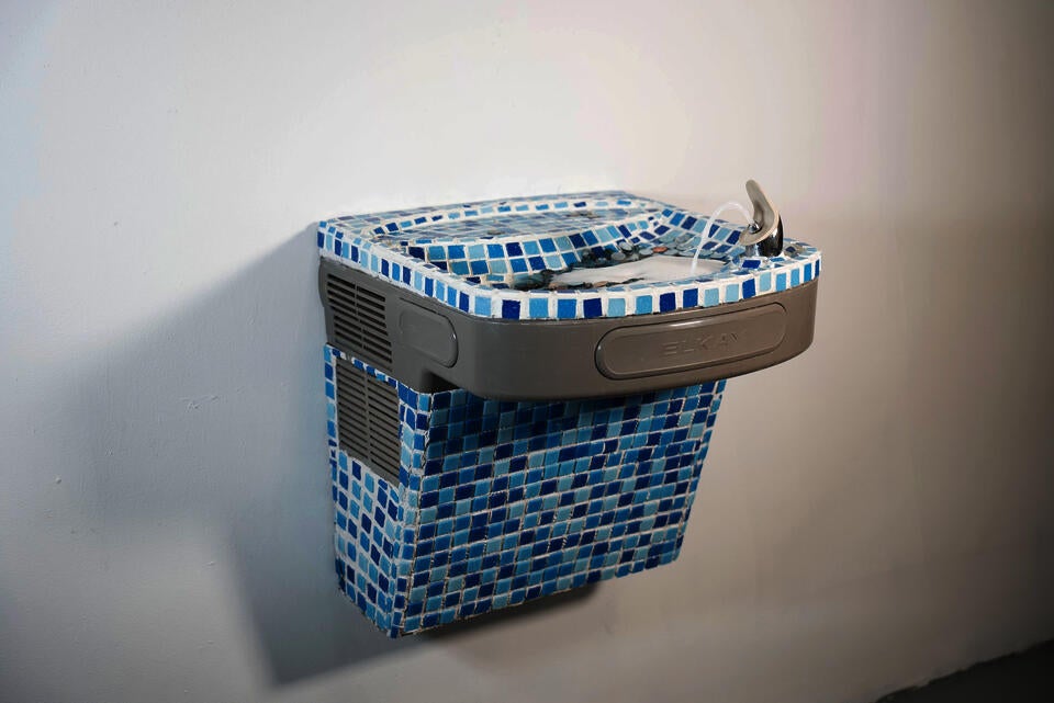 Tiled fountain flows with eroded coins and water, blending function and wishing well spirit—reflecting value, belief, memory.