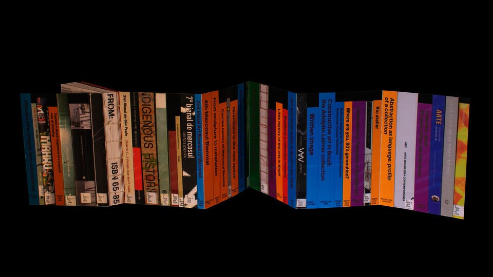 Book cover with accordion binding depicting several book spines in actual size.