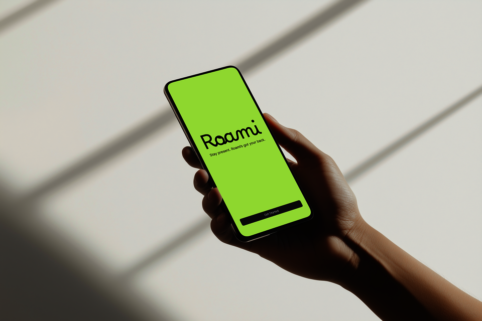 Minimal green landing screen for Roami AI showing logo, tagline “Stay present. Roami’s got your back,” and a single “Get Started” button, designed to feel calm, simple, and welcoming.