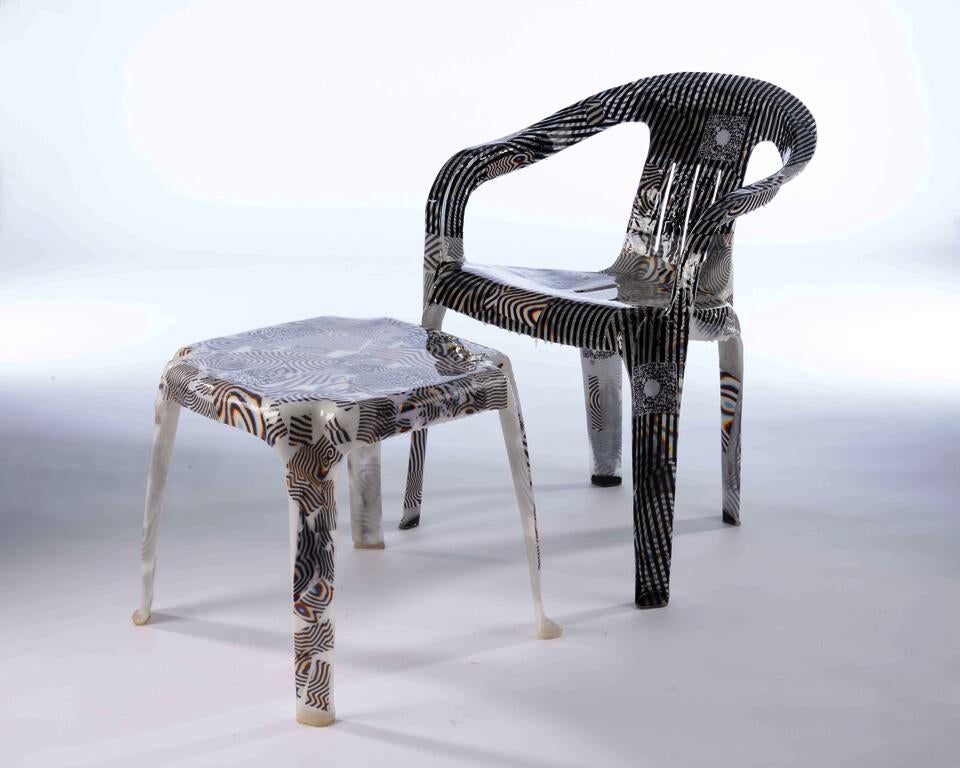 Glossy semi translucent fiberglass lawn chair and side table with funky psychedelic patterns embedded within.