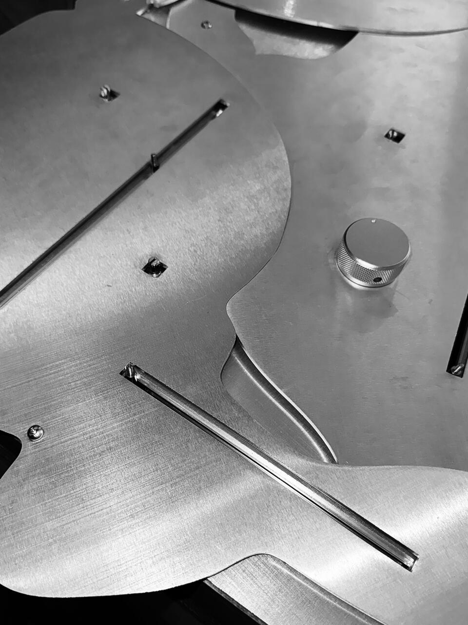 Close-up of a custom aluminum control panel with sliders and knobs, designed for an interactive installation that alters spatial and visual conditions through continuous adjustment.